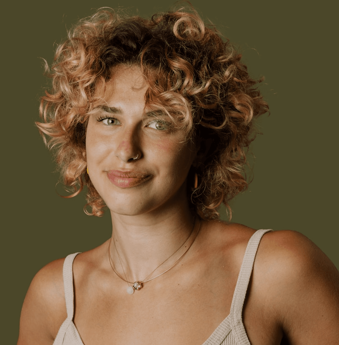 Portrait of a smiling woman with curly golden hair
