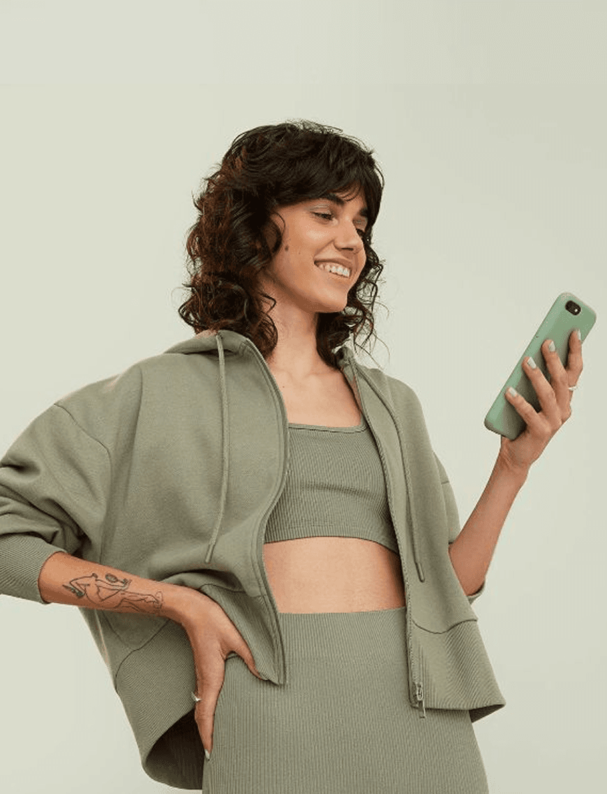 Smiling woman checking a new meeting request on her phone